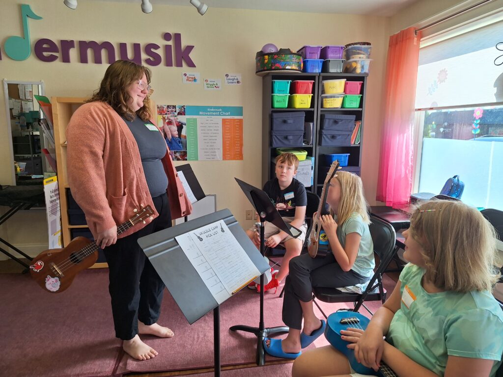 Children receiving ukulele instruction in the WPMDC classroom.